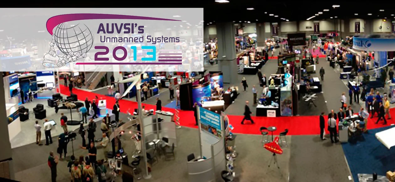 A busy exhibition hall filled with booths, attendees, and displays, showcasing the latest in unmanned systems technology.