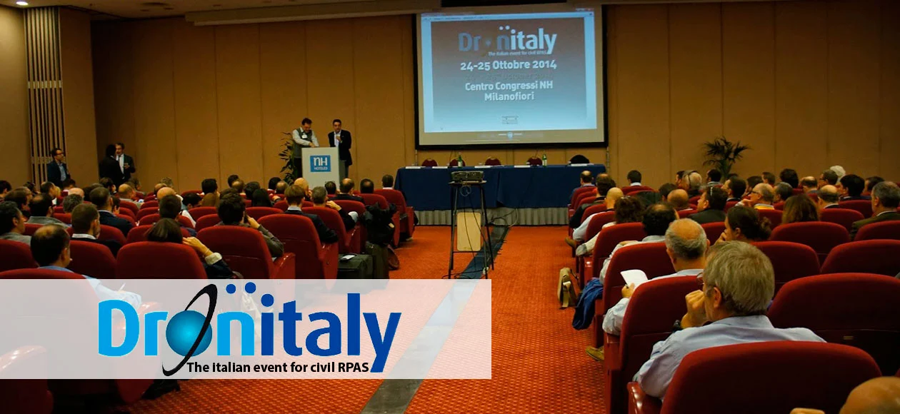Audience gathered at DronItaly 2014 in Milan, focused on a presentation about civil RPAS (Remotely Piloted Aircraft Systems).