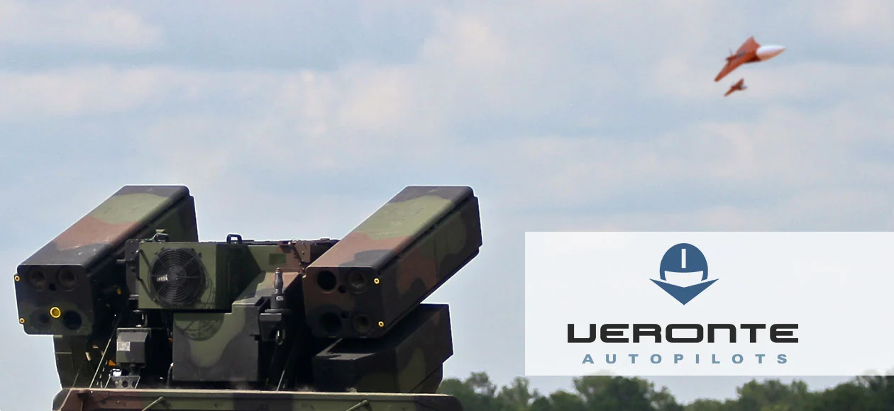 Autonomous target drone flying near a military defense system, demonstrating advanced unmanned technology in action.