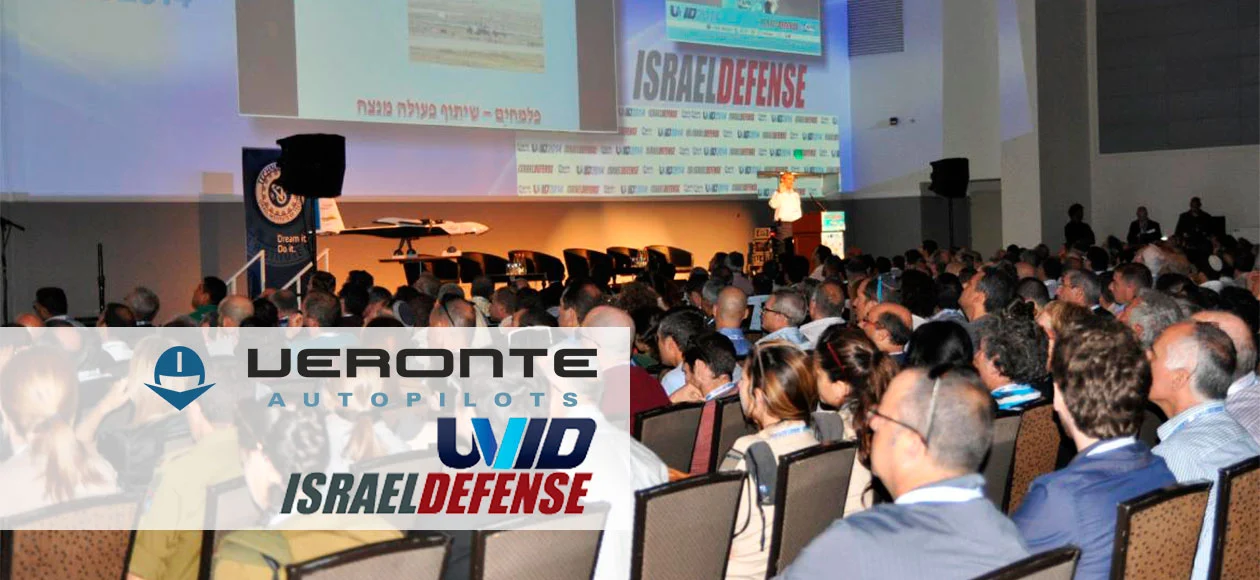 Audience at UVID 2015 conference watching a presentation, with logos of Veronte Autopilots and Israel Defense.