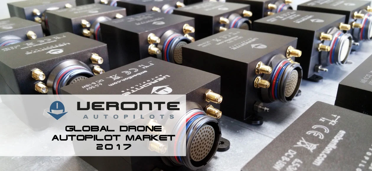 A collection of black, box-shaped Veronte autopilot units arranged on a table for display.