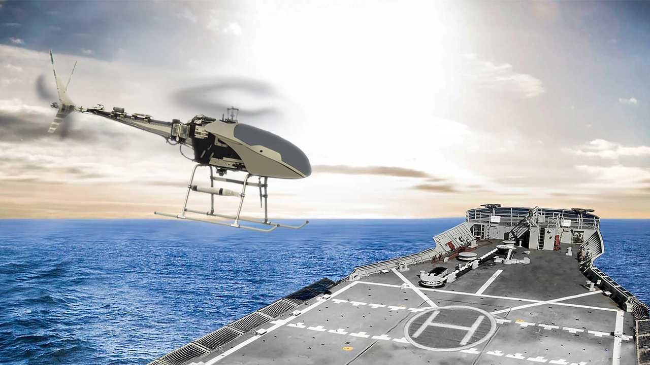 Unmanned aerial vehicle (UAV) approaching a landing on a mobile platform at sea under clear skies.